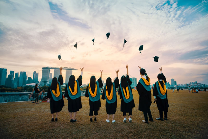 Young graduates throw their hats in the air