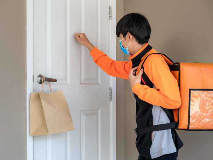 Food delivery rider knocking on door