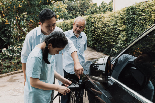 A family charging their electric vehicle.