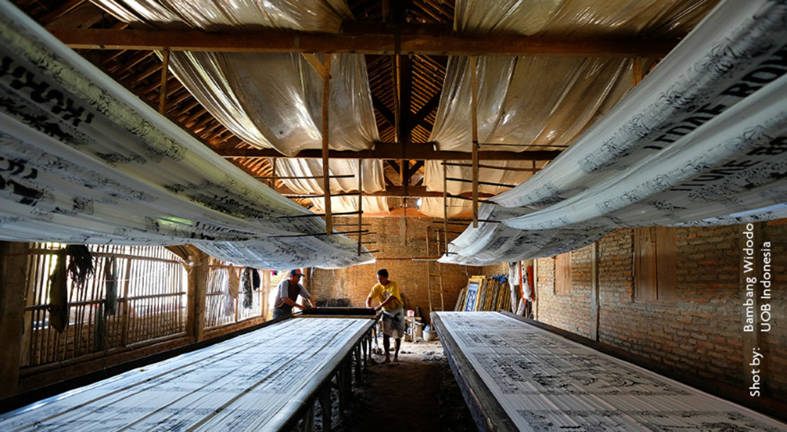 Two men working in a fabric printing facility