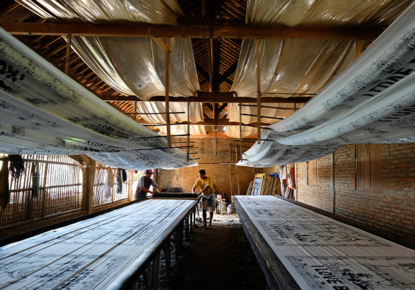 Two men working in a fabric printing facility