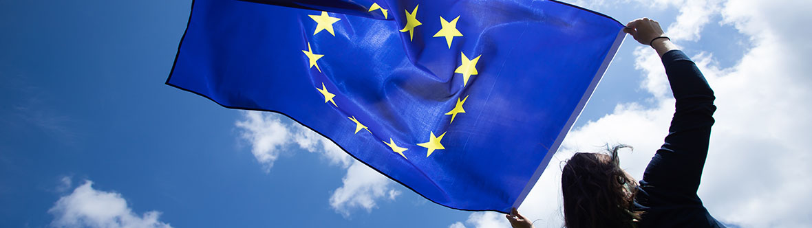 Woman holds up the European Union flag