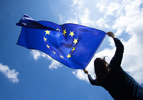 Woman holds up the European Union flag