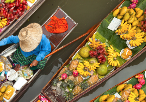 Top view of a fruit seller in his boat at a floating market in Thailand